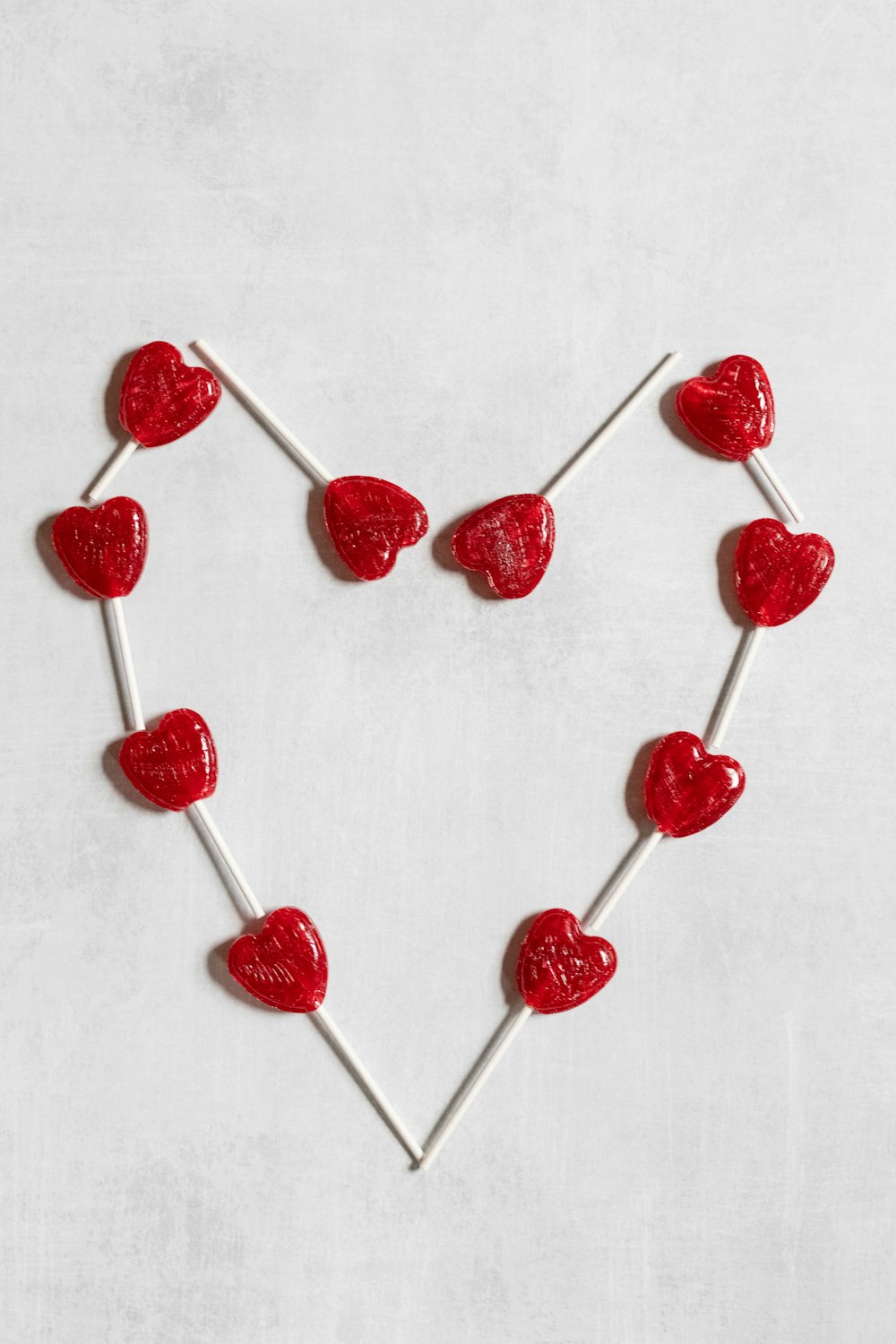 a heart shaped lollipop on a stick