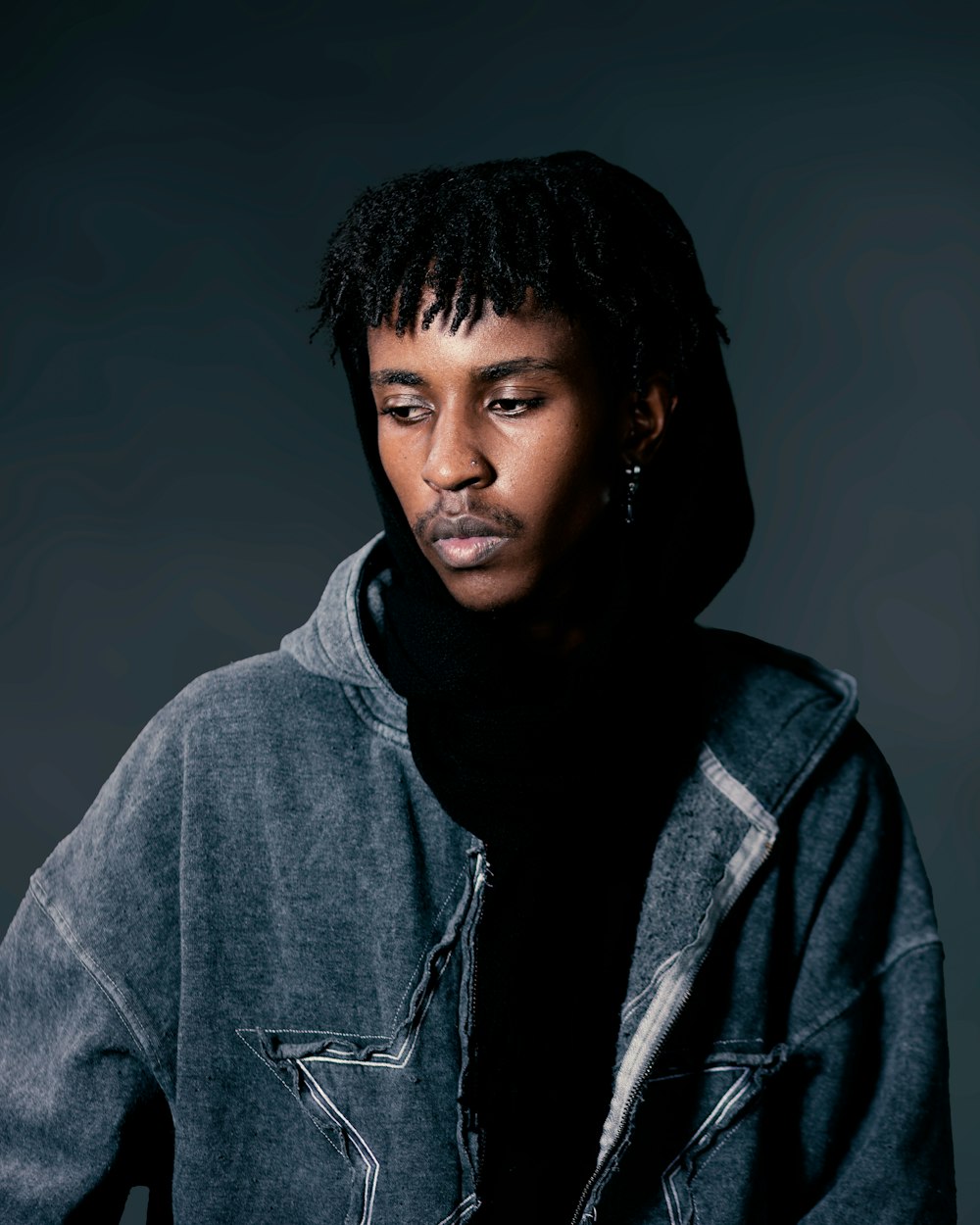 a man with dreadlocks is posing for a picture