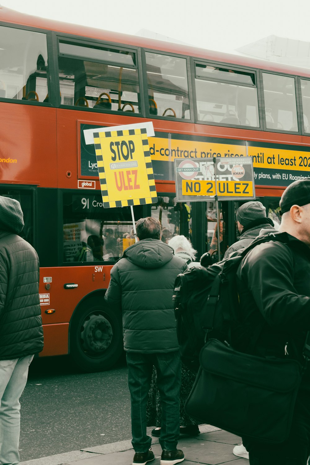 a group of people standing in front of a bus