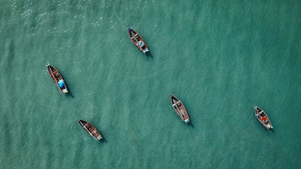 a group of boats floating on top of a body of water