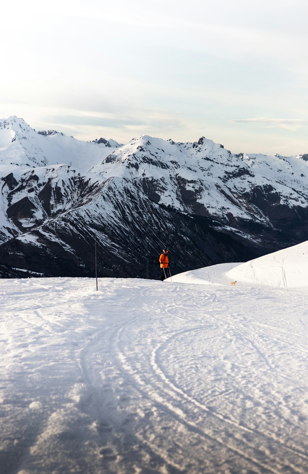 a man standing on top of a snow covered slope