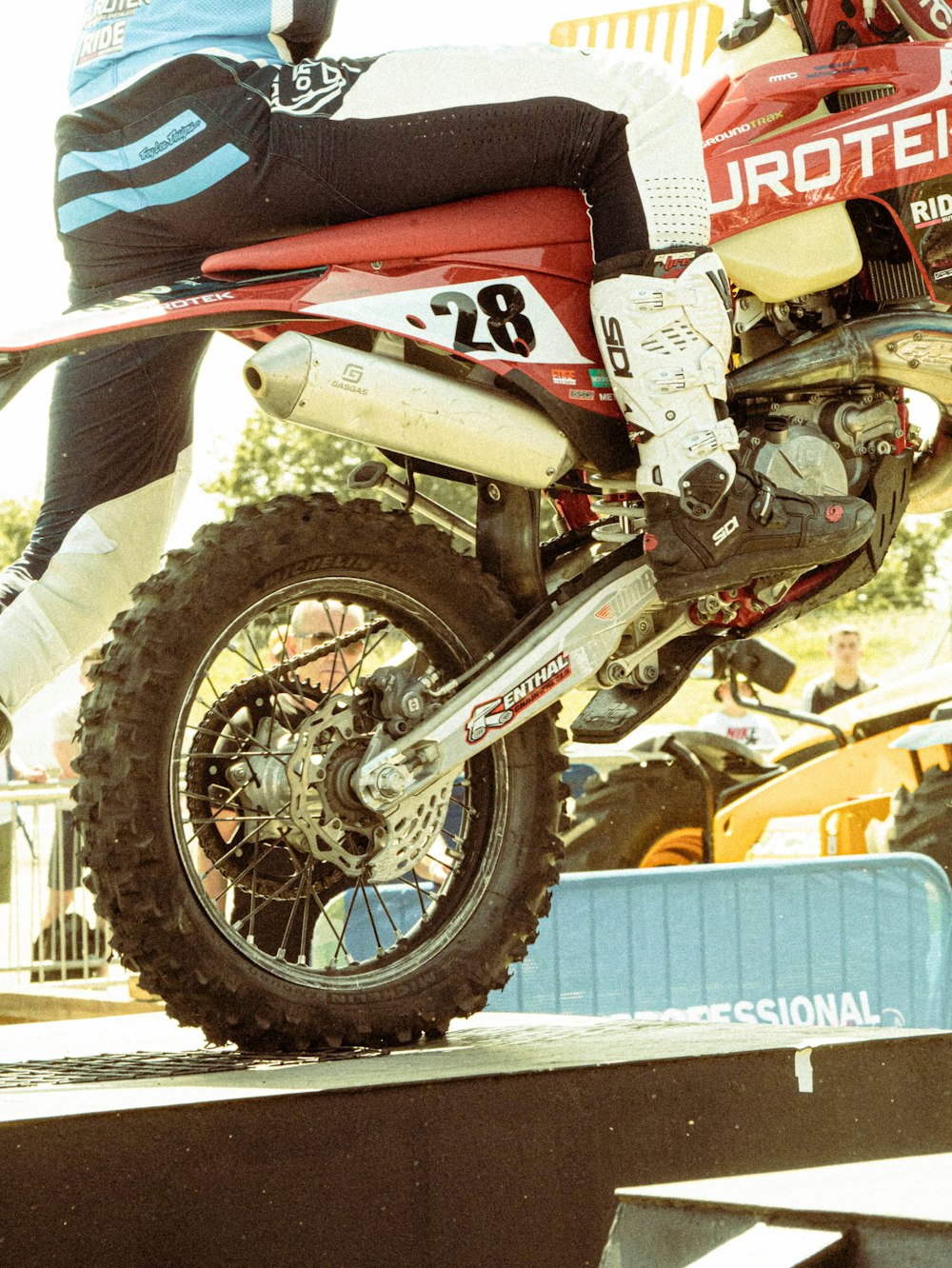 a man riding a dirt bike on top of a ramp