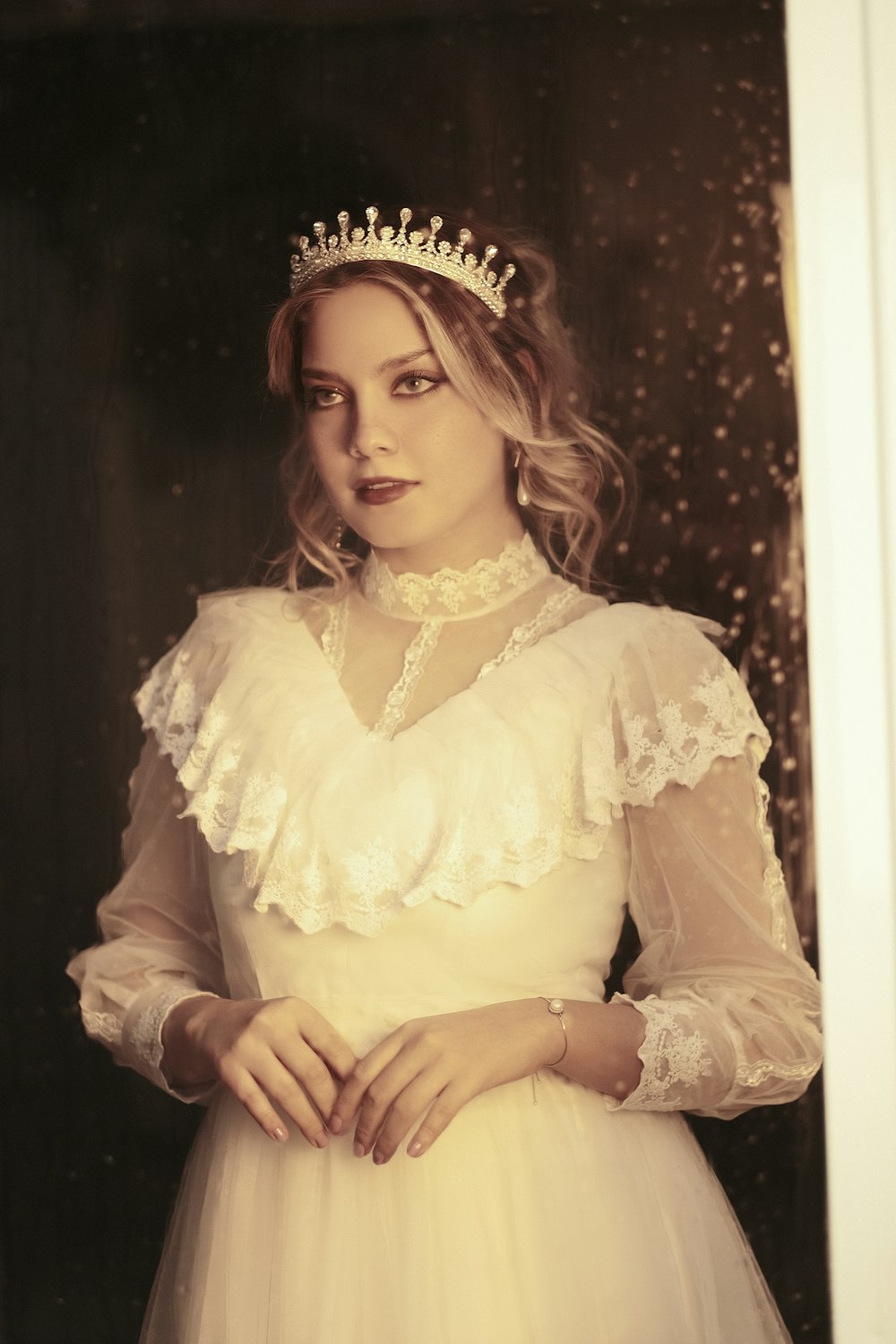 a woman in a white dress wearing a tiara