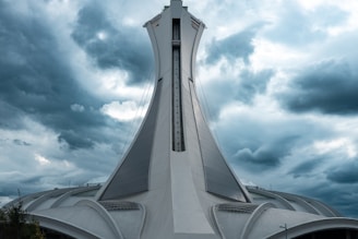 a tall white building with a cross on top of it