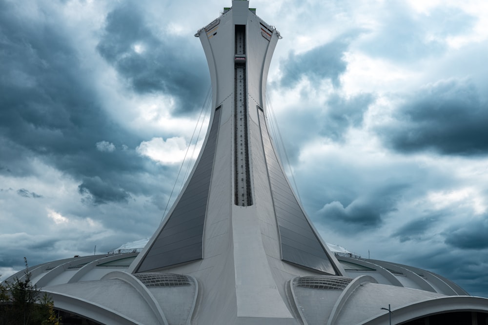 a tall white building with a cross on top of it