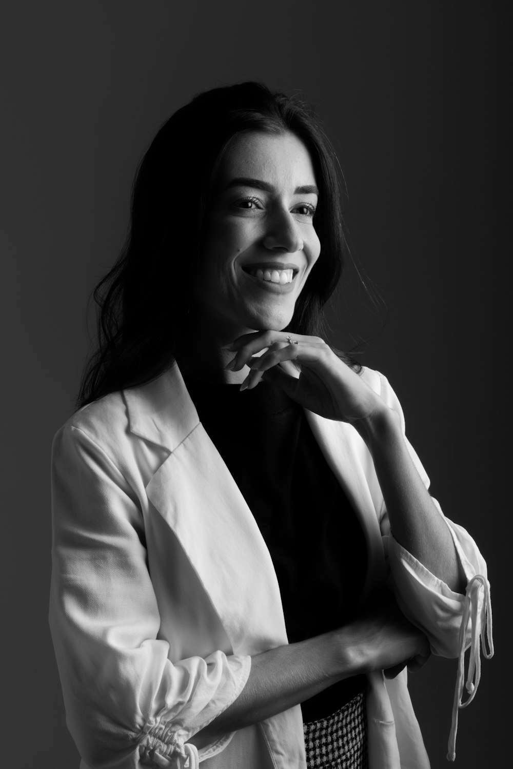 a black and white photo of a woman smiling