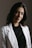 a woman wearing a white jacket and black shirt