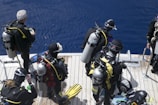 a group of scuba divers on a boat