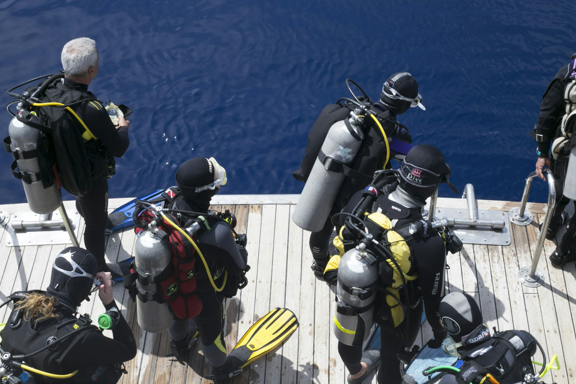 a group of scuba divers on a boat