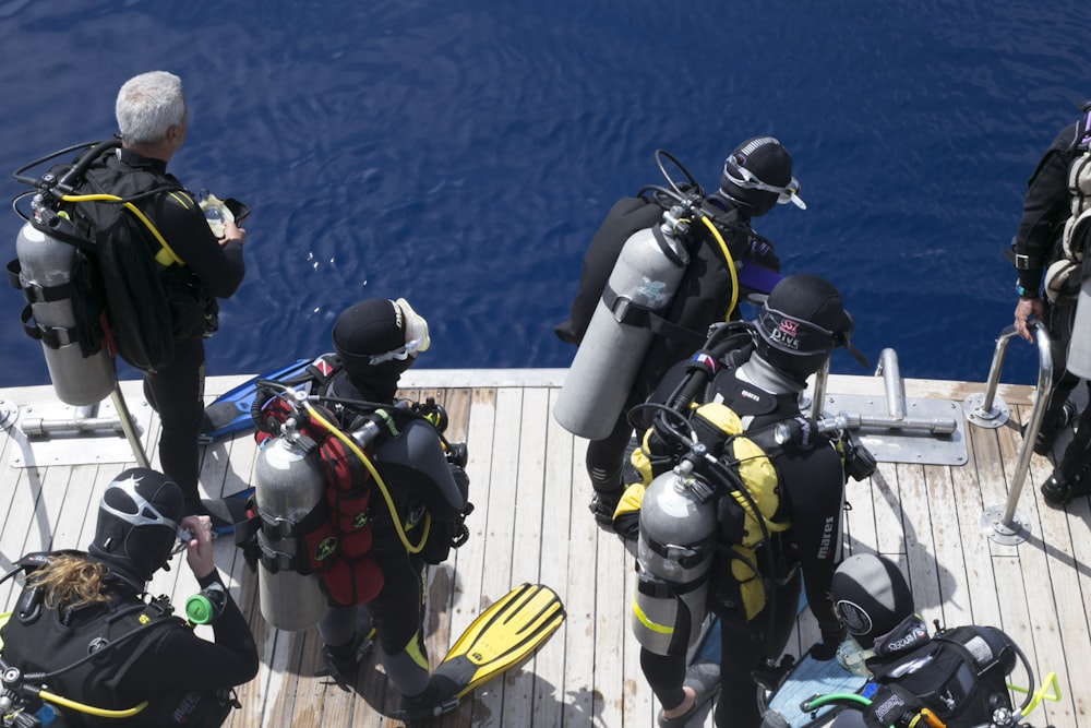 a group of scuba divers on a boat