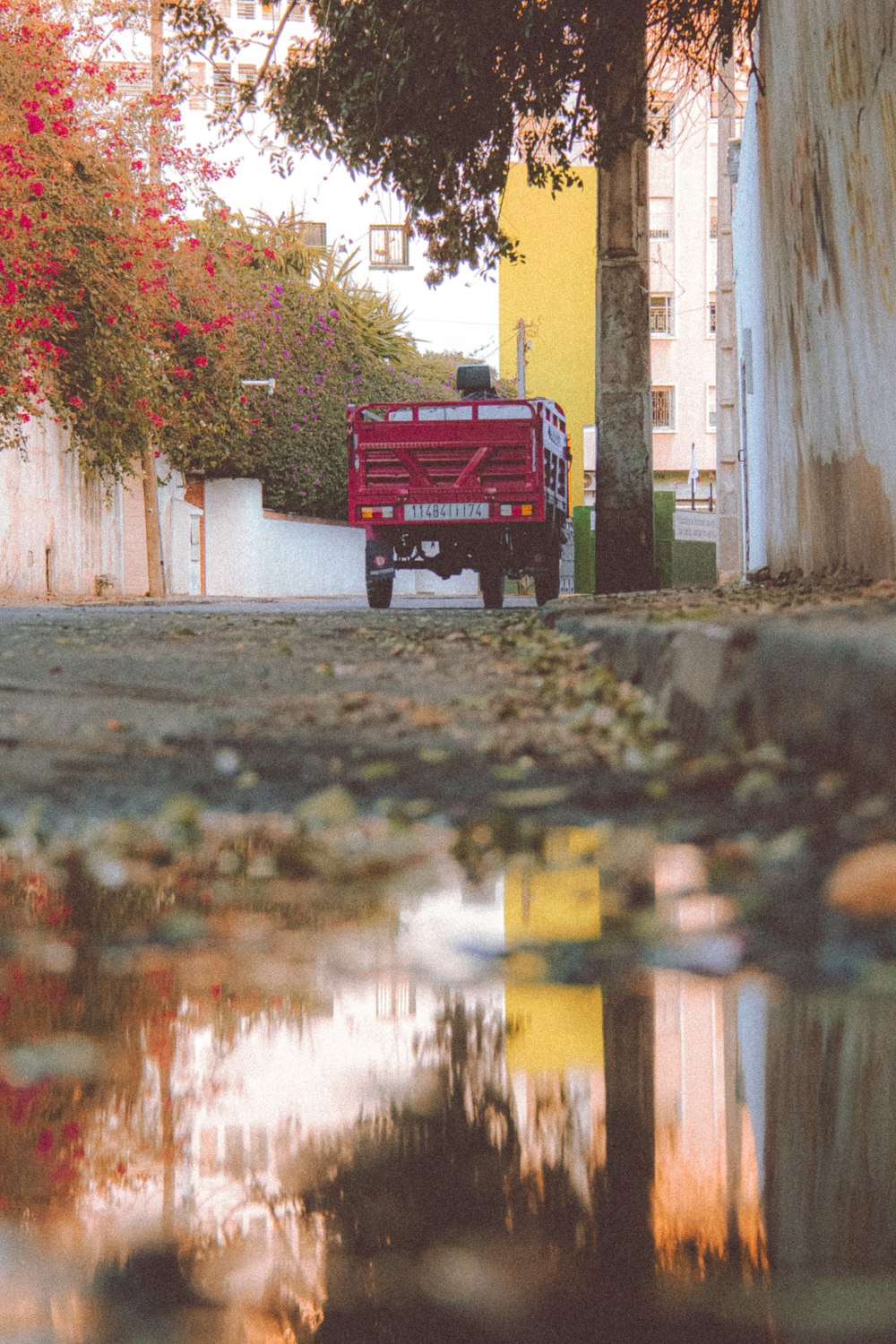 a red truck parked on the side of a road