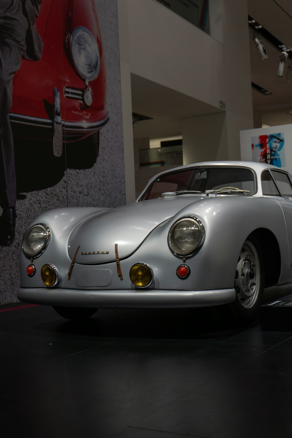 a silver sports car on display in a museum