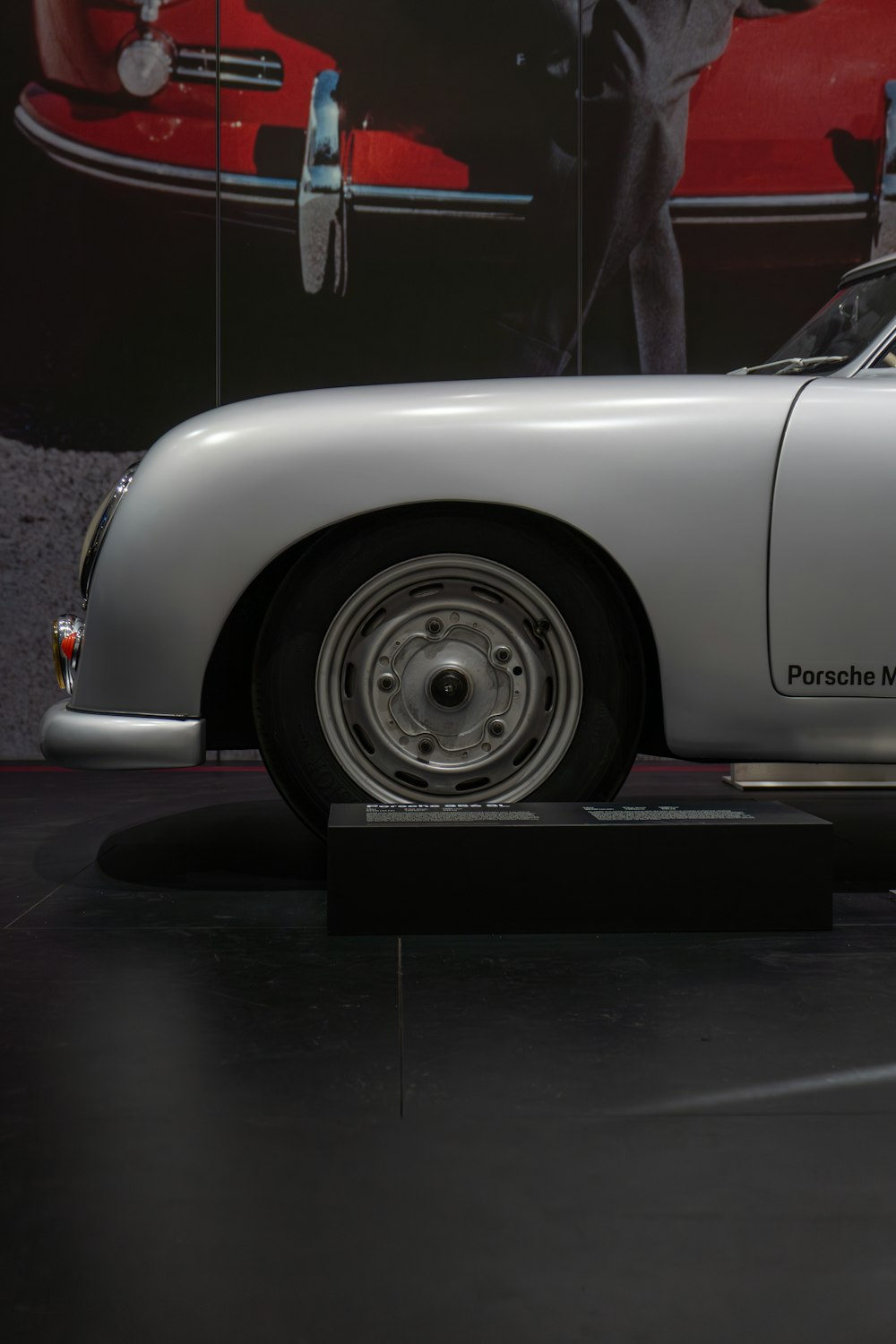 a white sports car on display in a museum