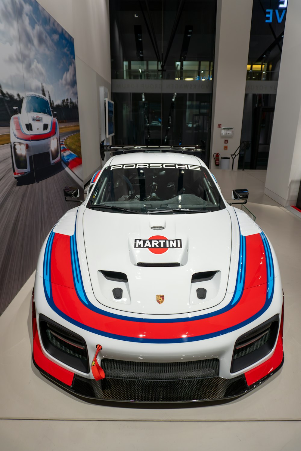 a white sports car with red, blue, and white stripes