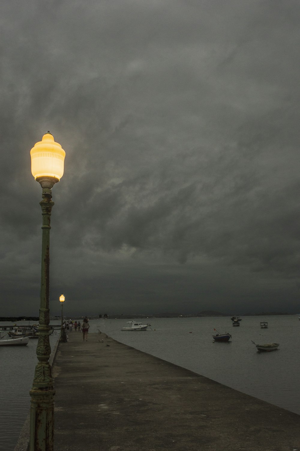 a street light sitting on the side of a pier