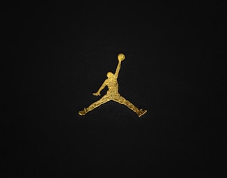 a gold air jordan logo on a black background