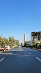 a truck is driving down a street in a city