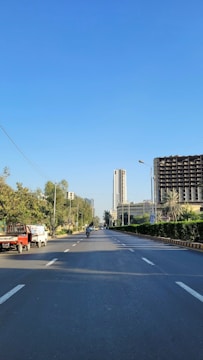 a truck is driving down a street in a city