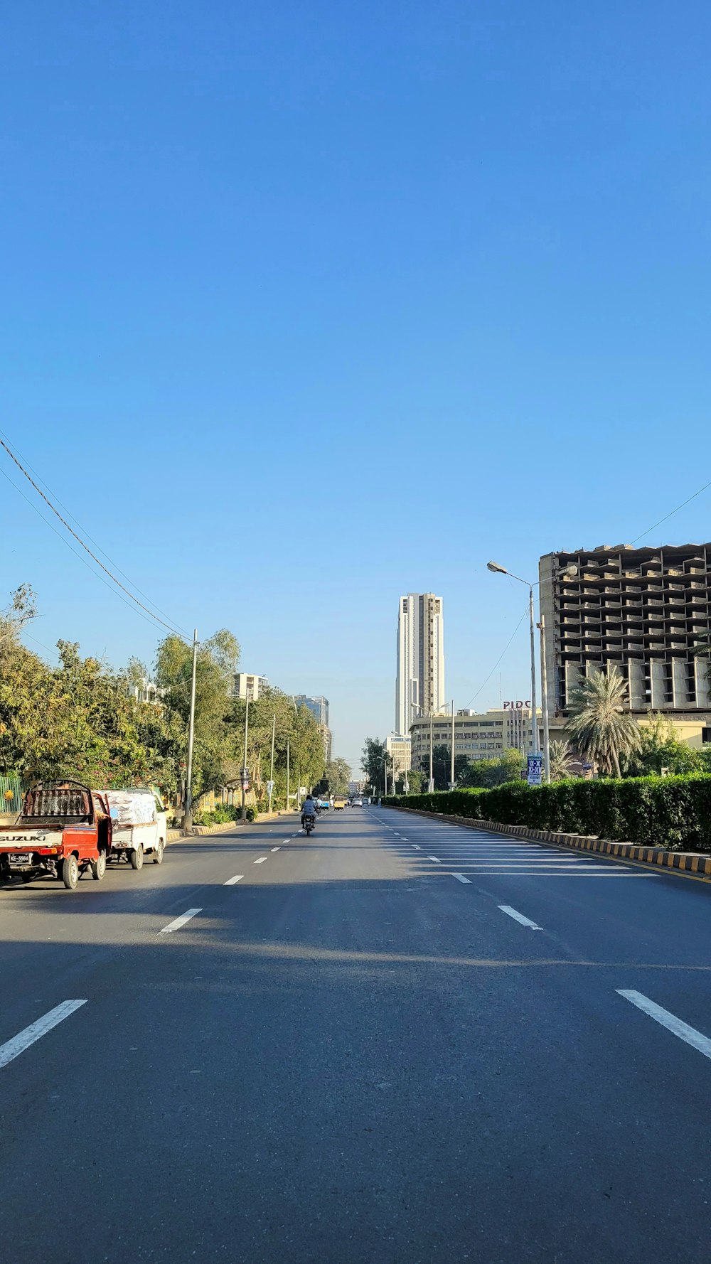 a truck is driving down a street in a city