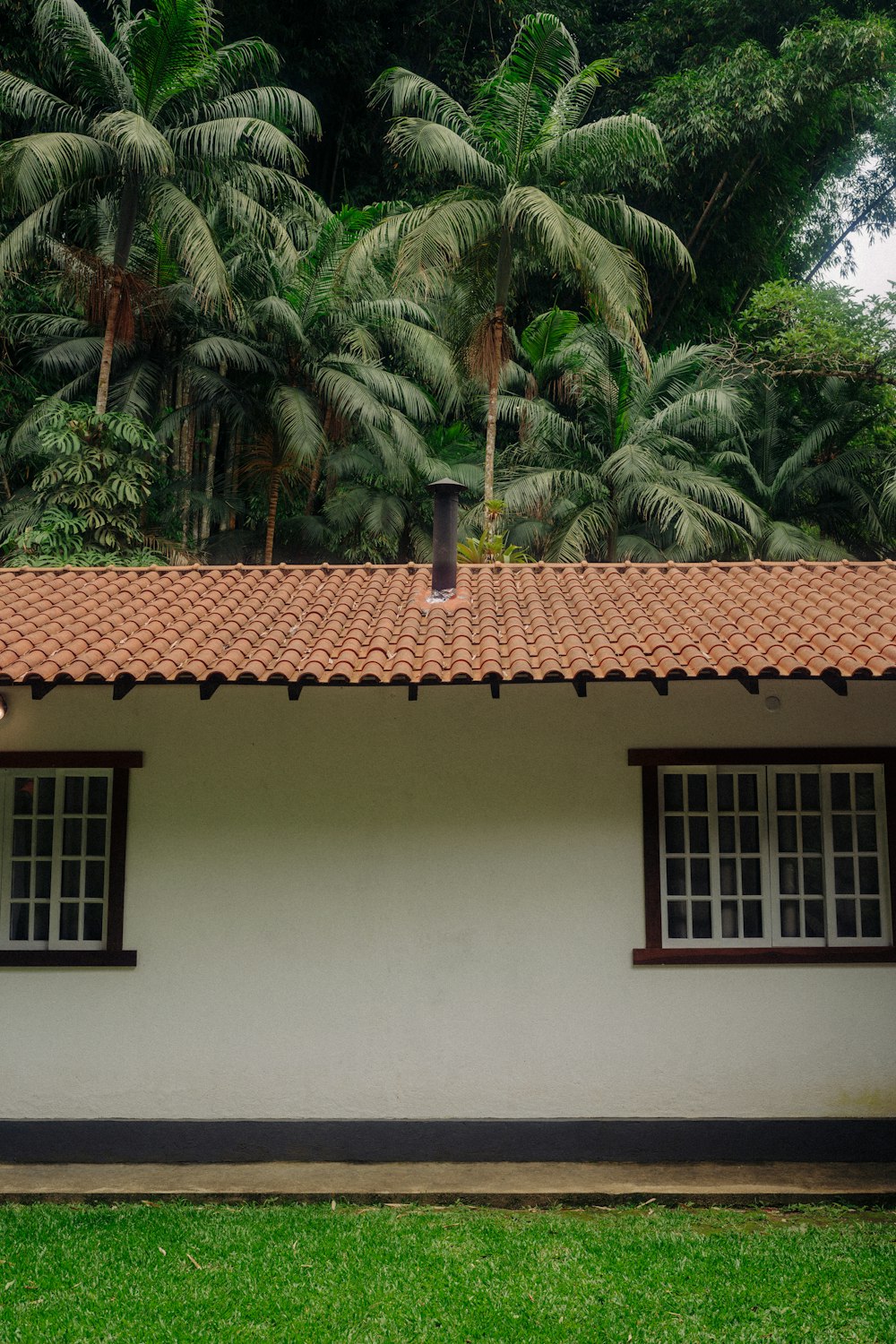 a white house with a red tiled roof