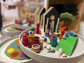 a white table topped with plates filled with different types of crafts