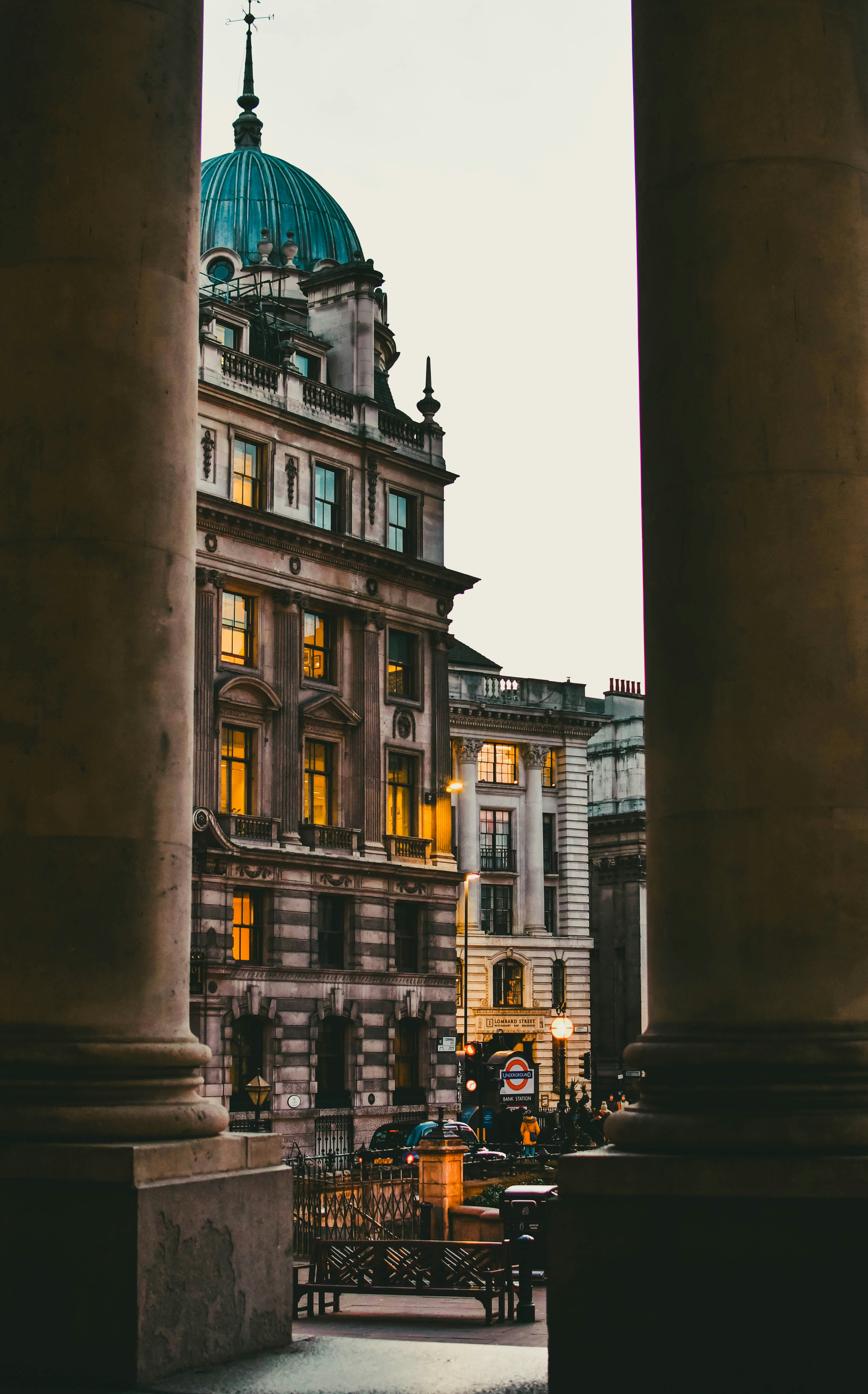 a view of a building through some pillars