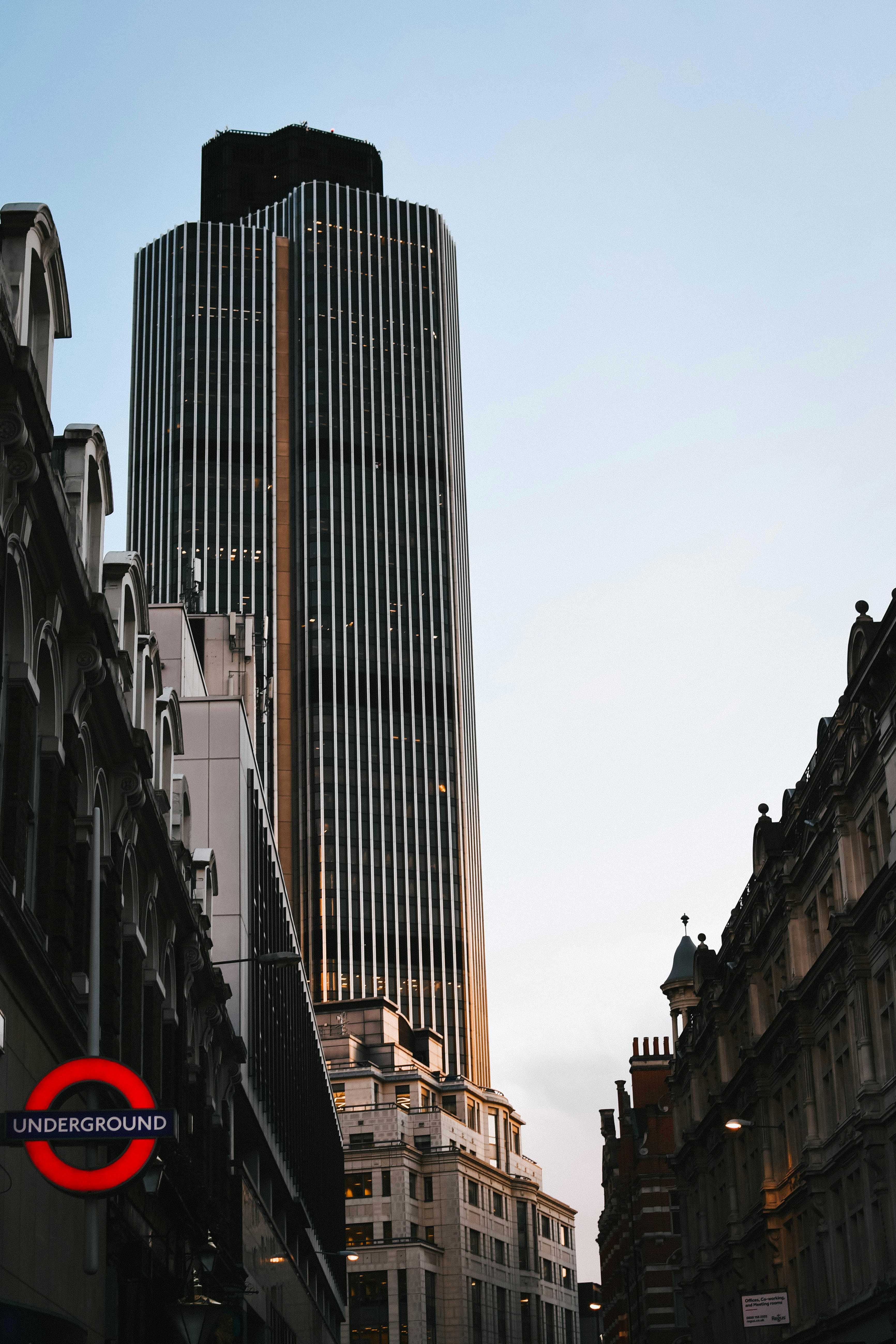 a tall building with a red sign in front of it