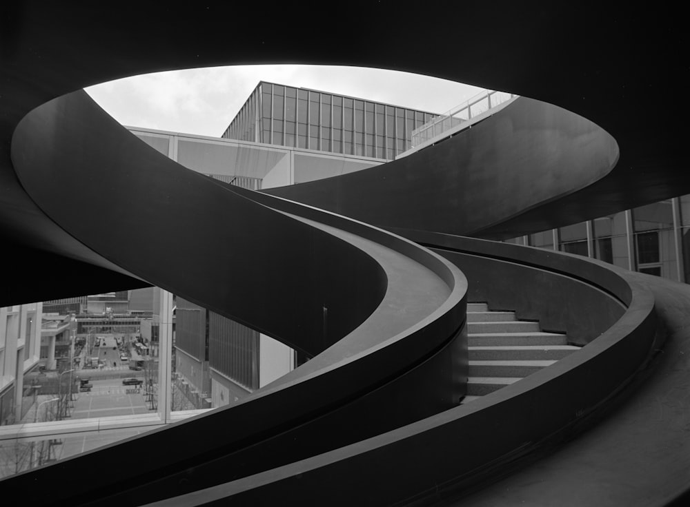 a black and white photo of a spiral staircase