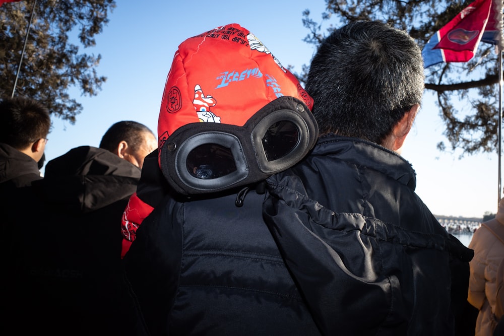 a man wearing a red hat and goggles