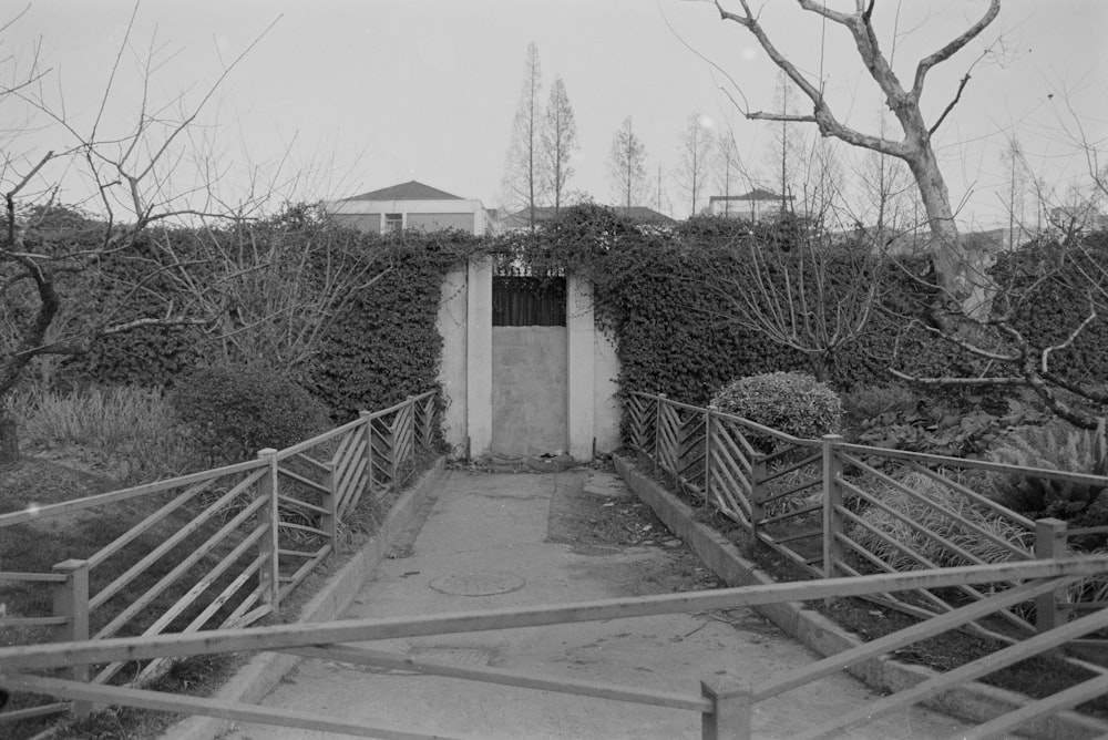 a black and white photo of a gated entrance