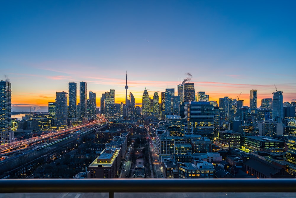 a view of a city at sunset from a balcony