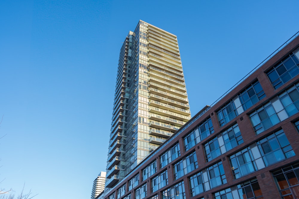 a tall building next to a very tall building