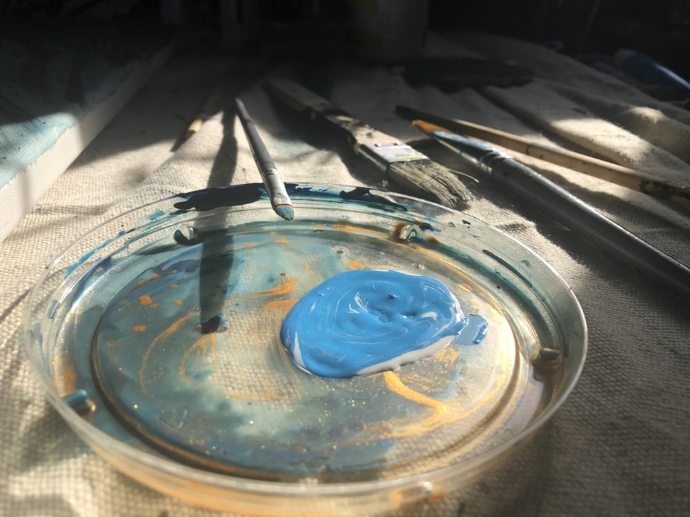 a glass bowl with a blue substance inside of it