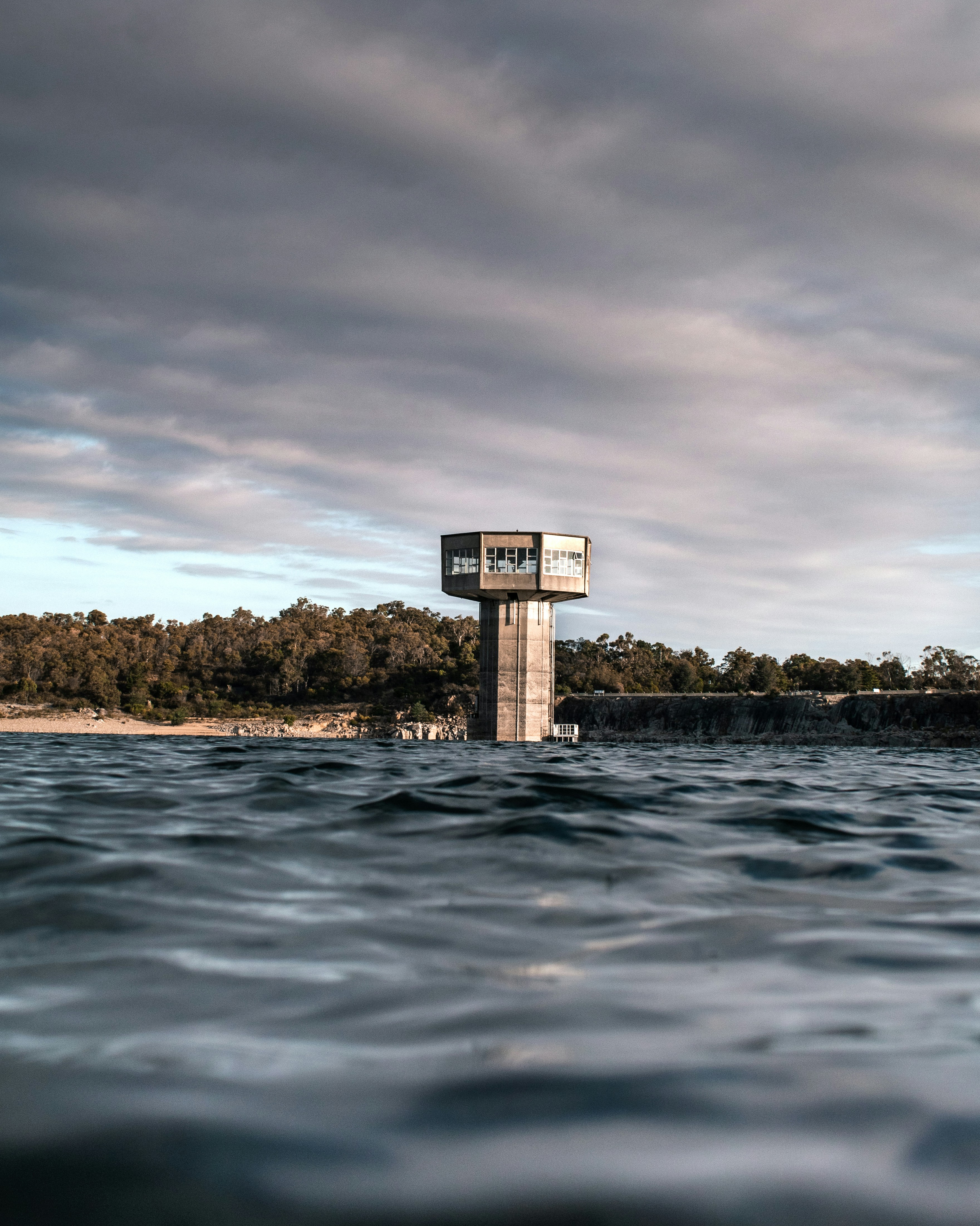 a tower in the middle of a body of water