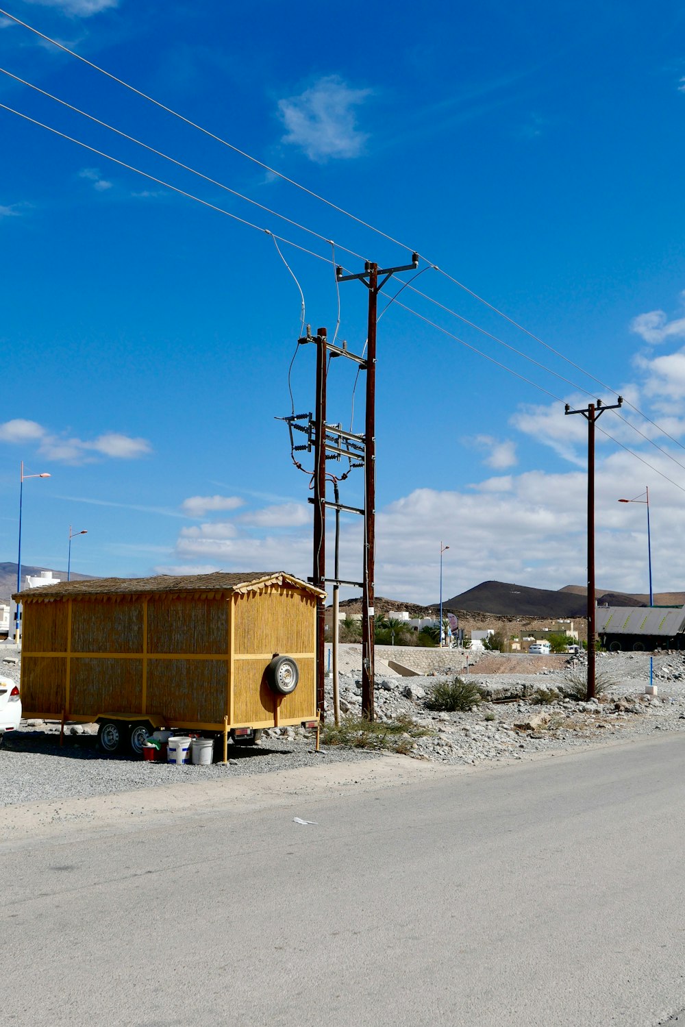 a yellow box sitting on the side of a road