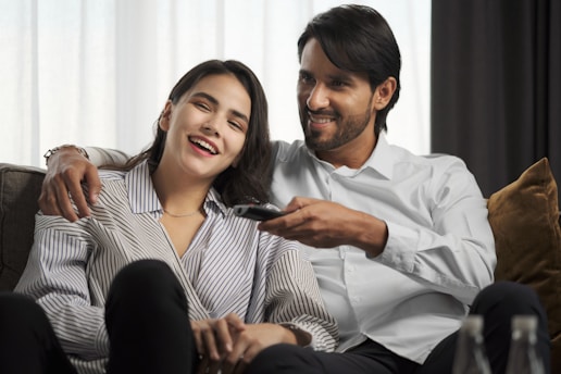a man sitting next to a woman on a couch