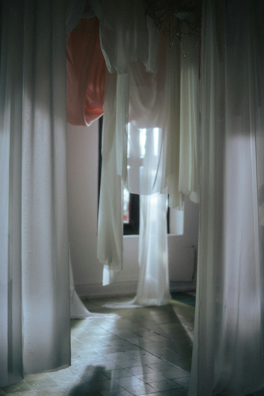 a room with curtains and a cat on the floor