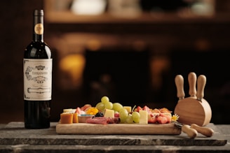 a bottle of wine next to a platter of food