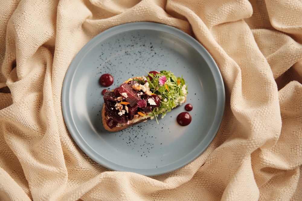 a blue plate topped with a piece of food