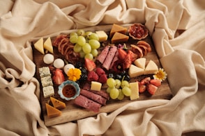 a wooden board topped with lots of different types of food