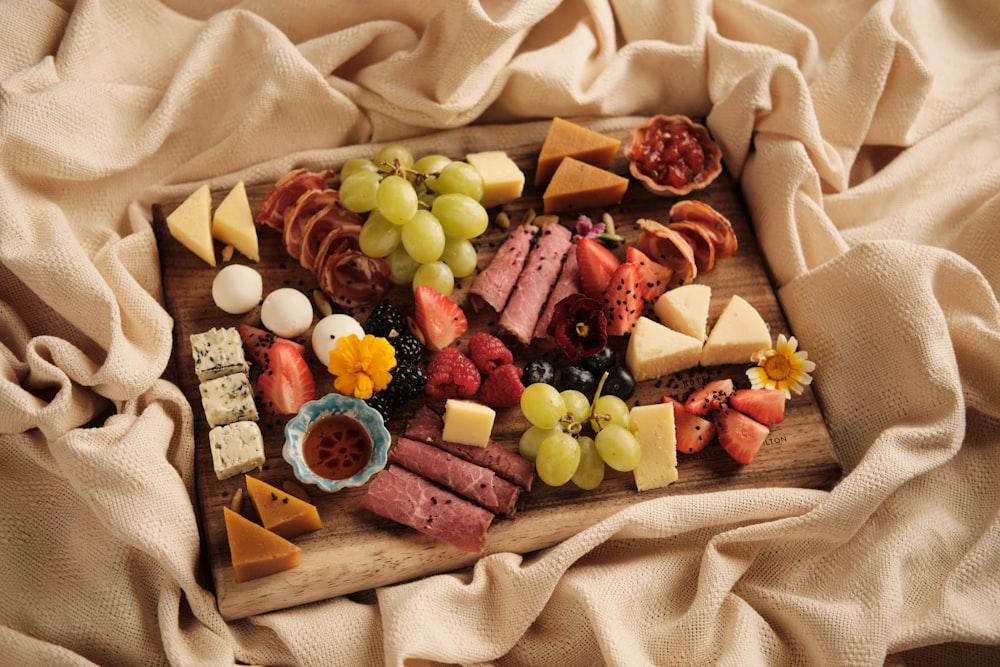 a wooden board topped with lots of different types of food