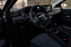 the interior of a car with a steering wheel and dashboard