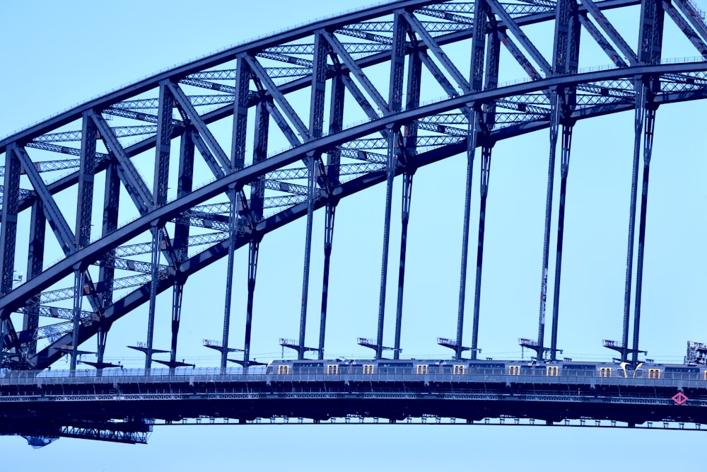 a train traveling over a bridge on a clear day