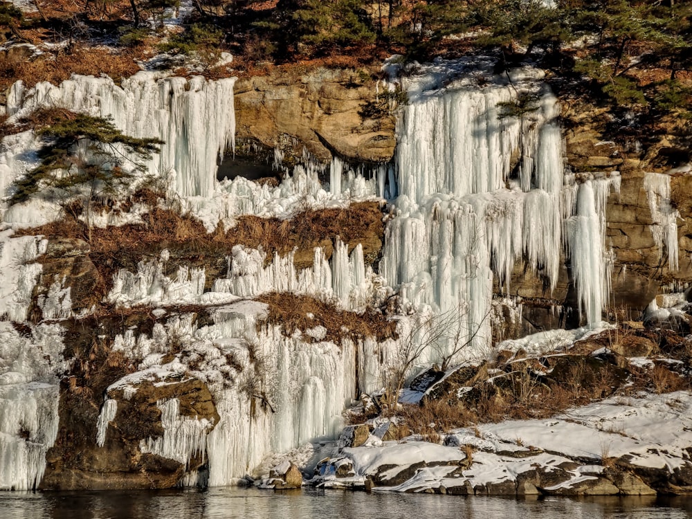 a large waterfall with ice hanging off of it's sides