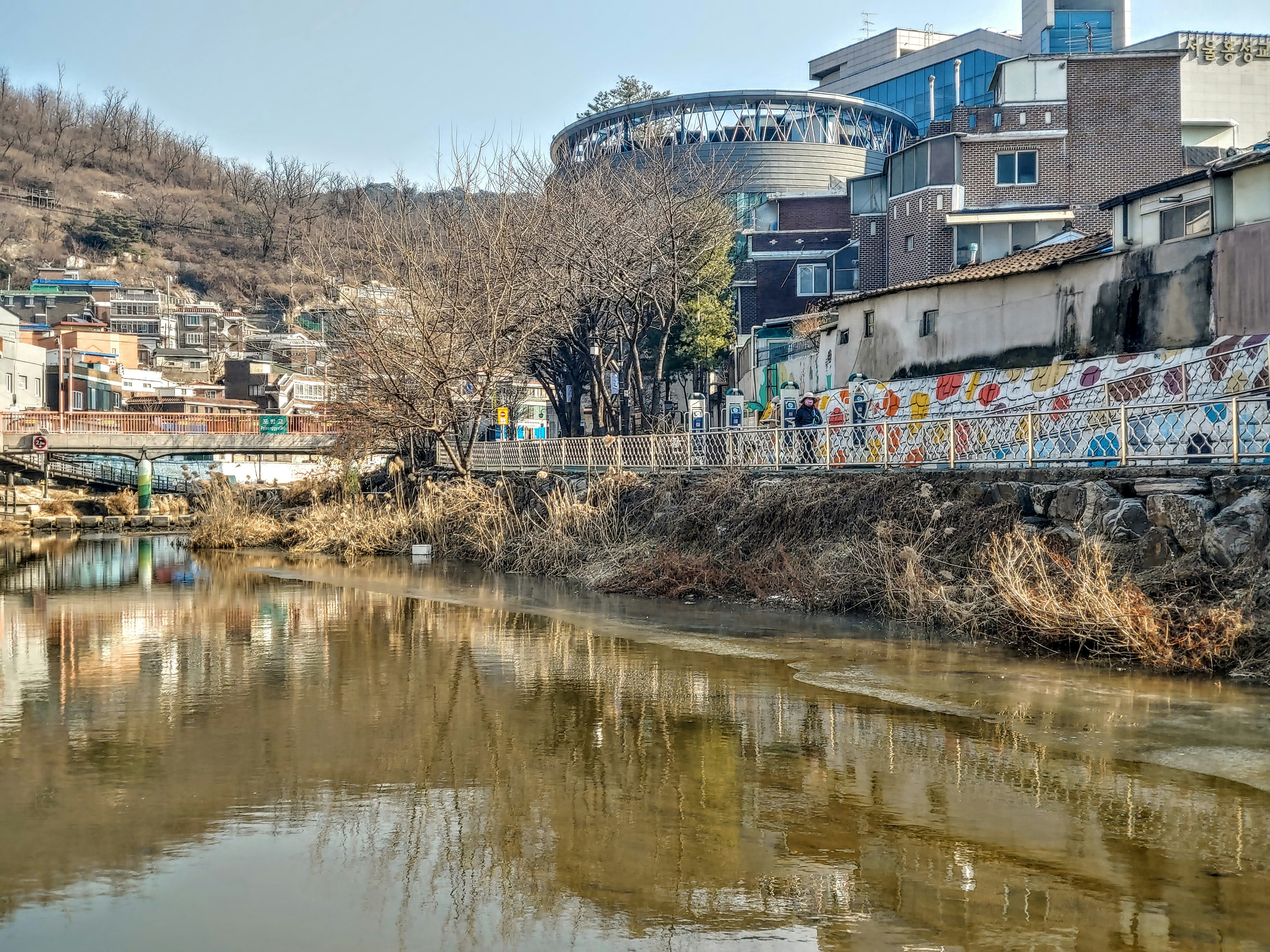 a river running through a city next to tall buildings