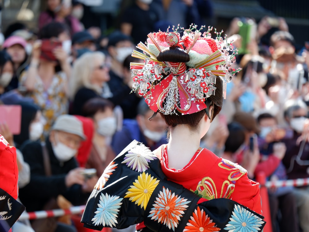 a woman in a red kimono and a crowd of people