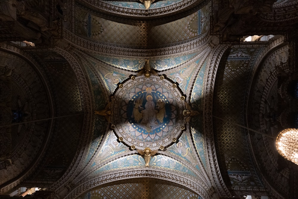 the ceiling of a large building with intricate designs