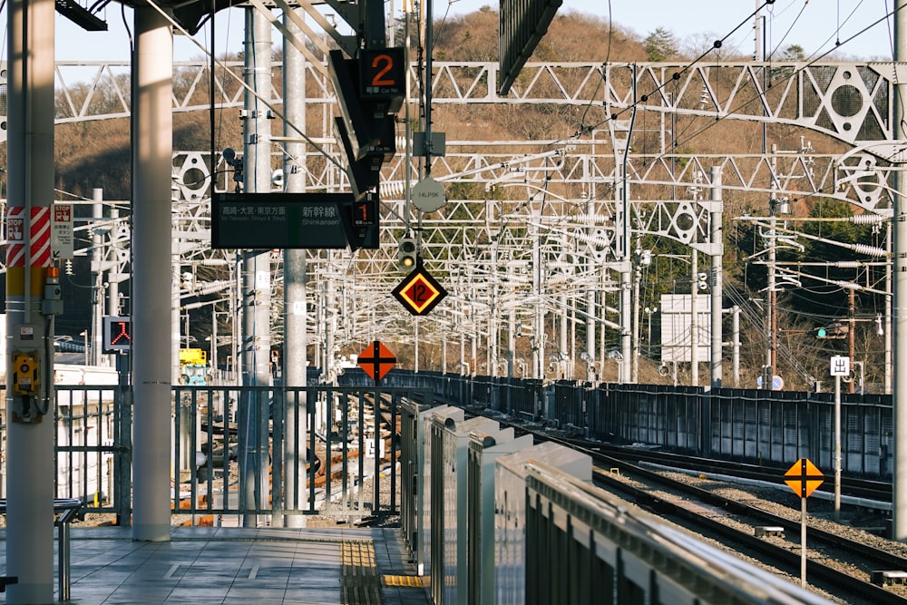 a train traveling down train tracks next to a train station