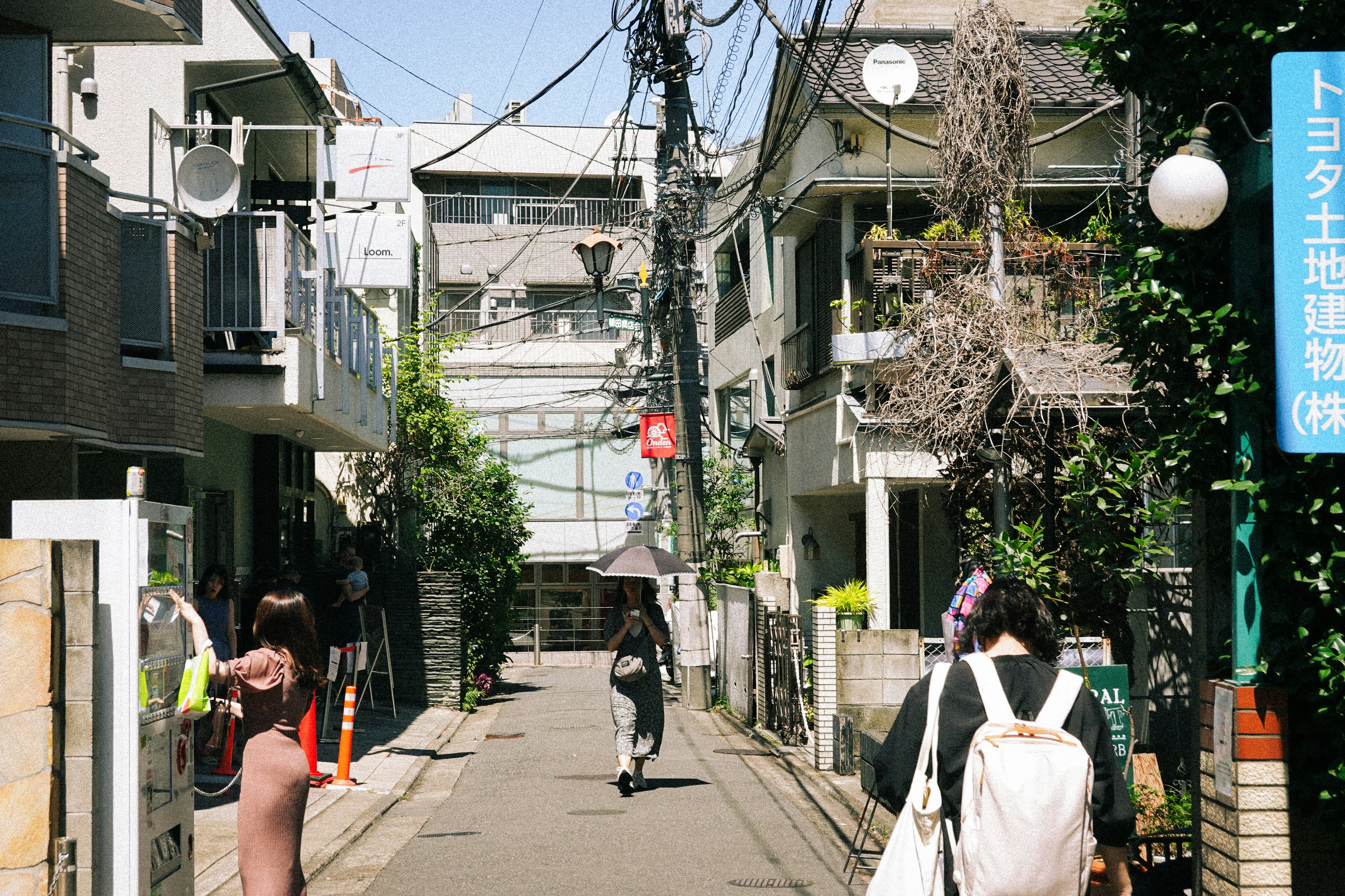 a couple of people walking down a street