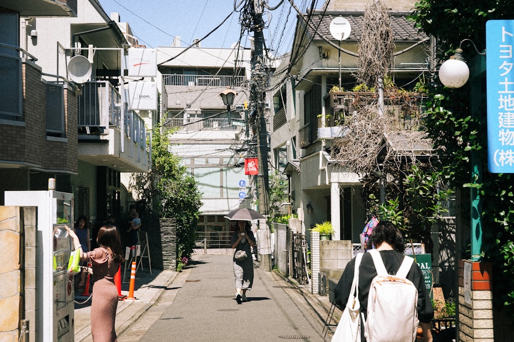 a couple of people walking down a street